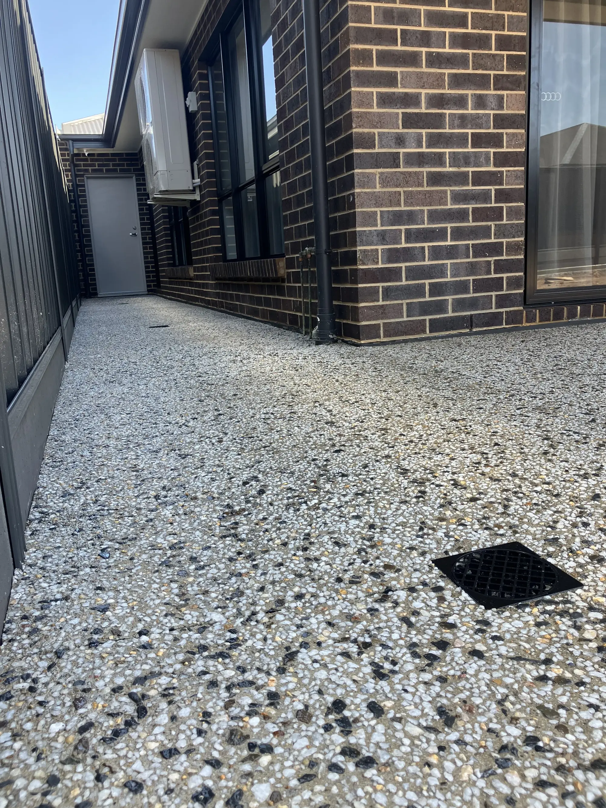 Drain in exposed aggregate concrete floor.