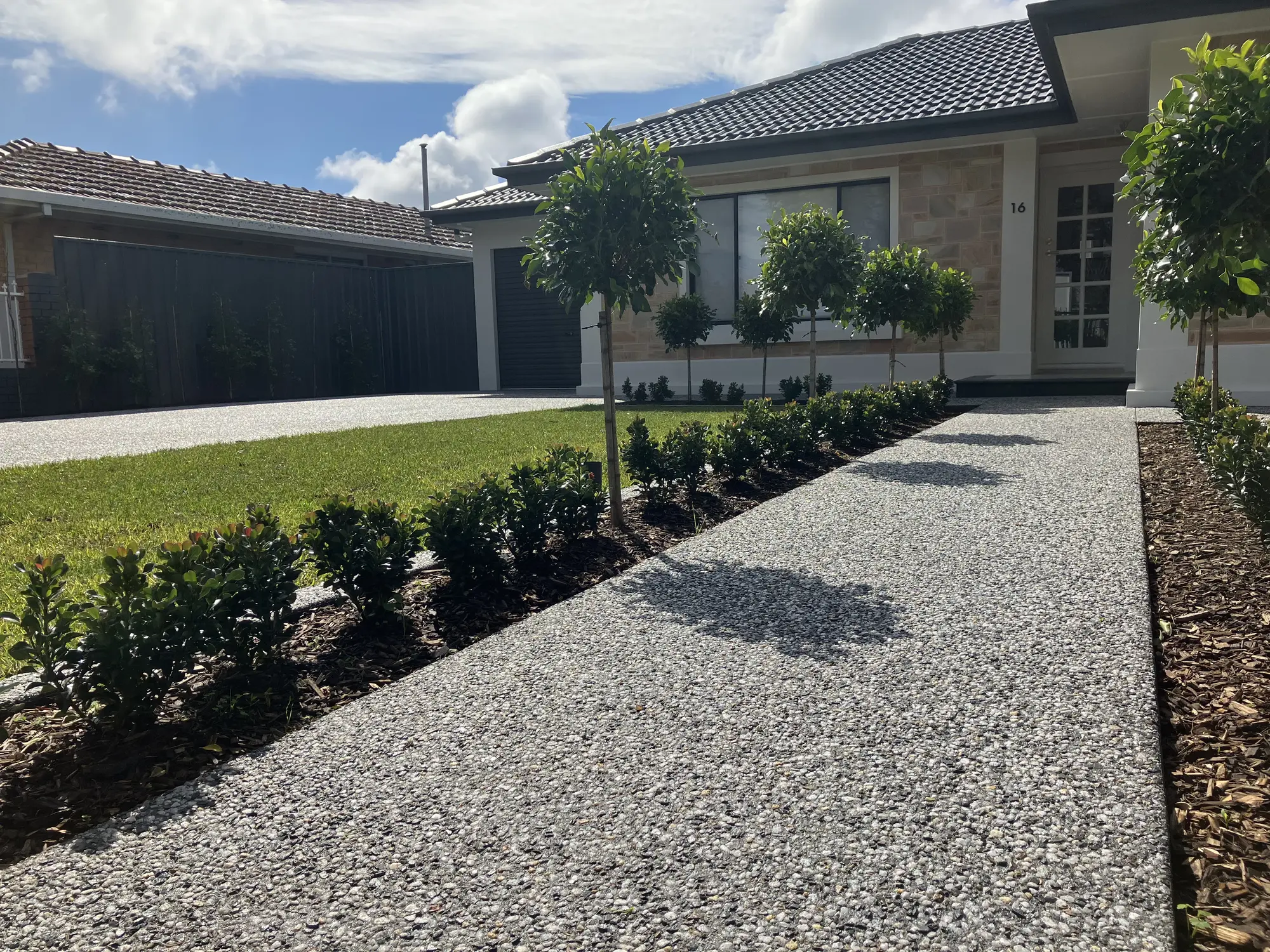 Exposed aggregate concrete leading to a house.
