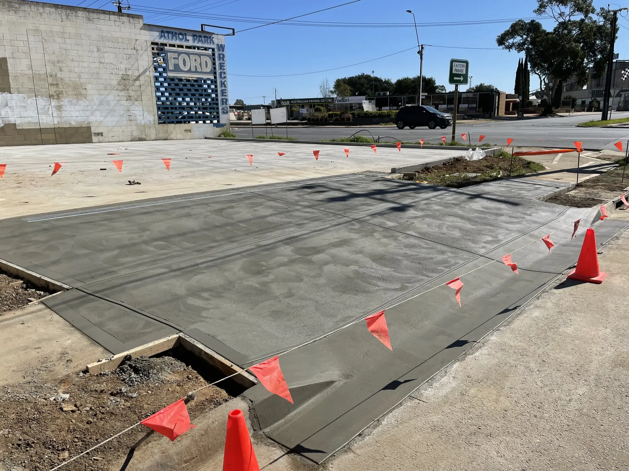 Plain concrete ramp leading to a parking lot.