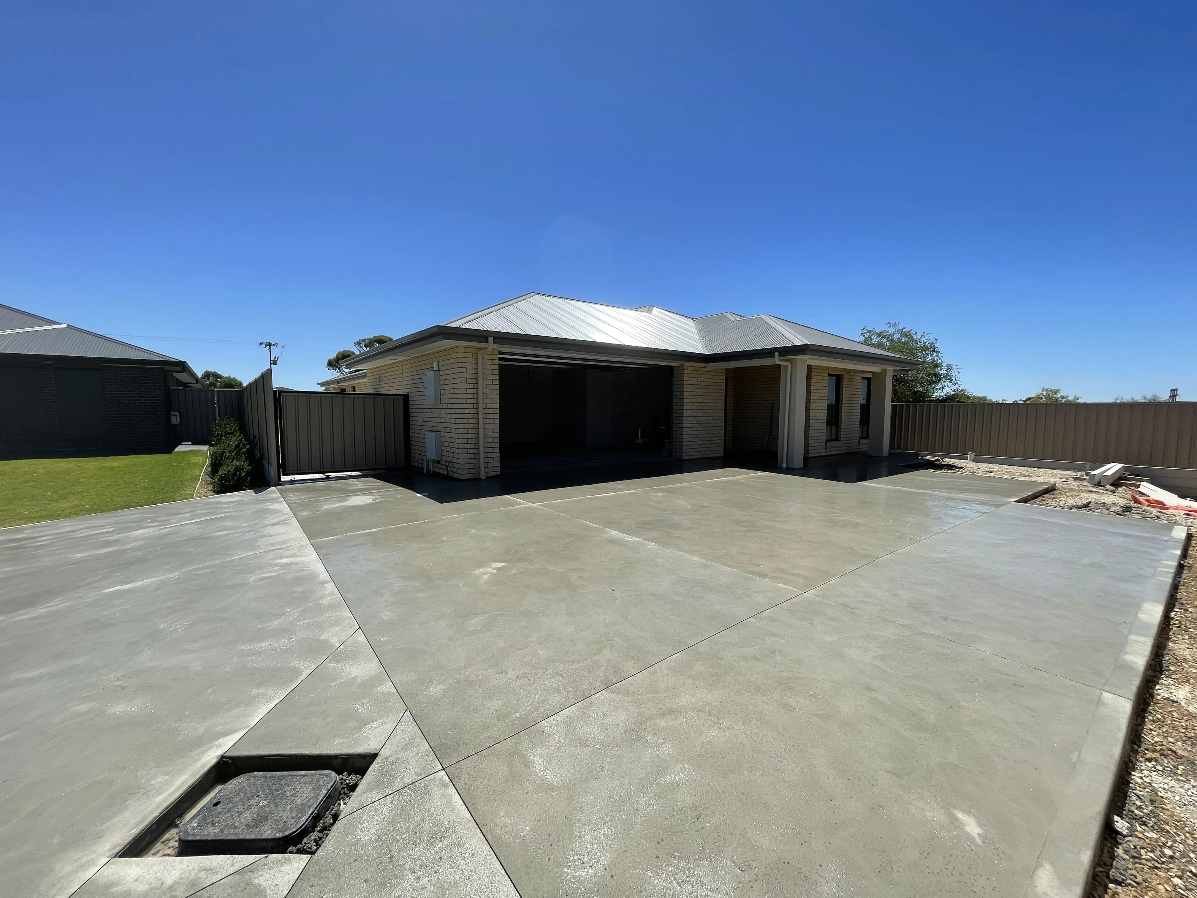 A concrete driveway of a house.